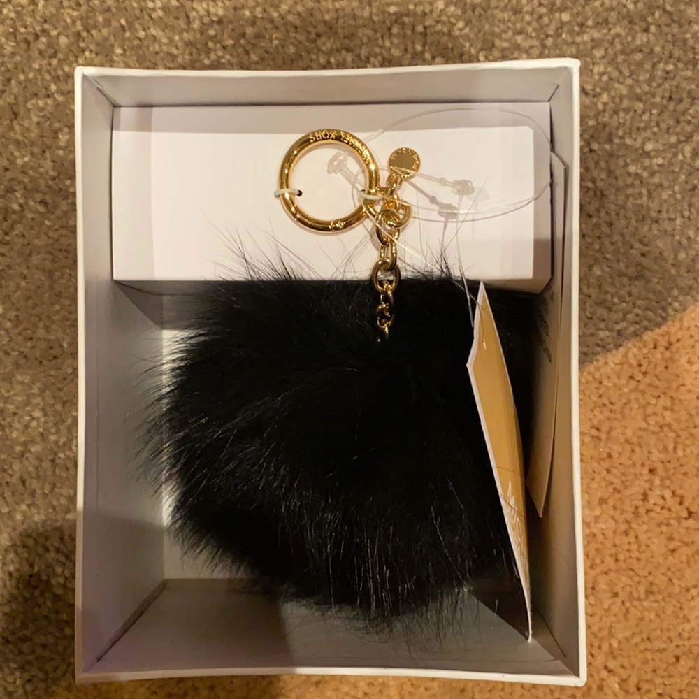 Black Michael Kors puff ball keychain
